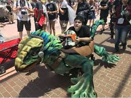 Boy sitting in his fabricated dragon wheelchair cover.