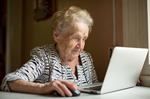 Older woman using a laptop computer.