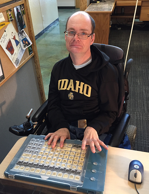 Mike Smith, an Idaho Assistive Technology employee, using an adaptive keyboard at work.